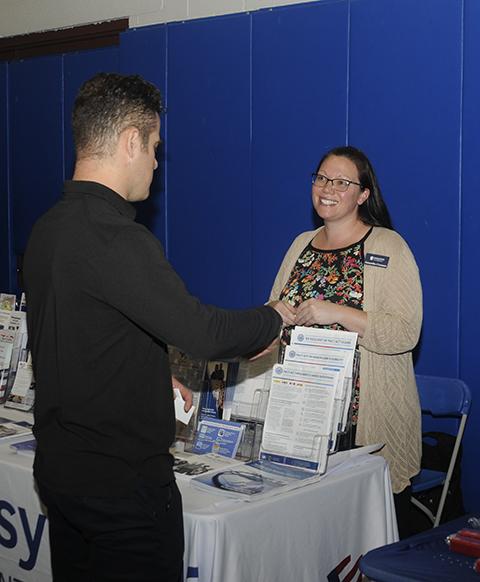 Samantha Cossman, from the Pennsylvania Department of Military and Veterans Affairs, talks with an expo attendee.