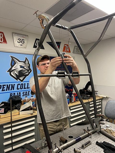 Stephen F. Goodwin, of Ellicott City, Md., and scheduled to graduate this Saturday with a bachelor’s degree in welding & fabrication engineering technology, measures the angle of a tube. 