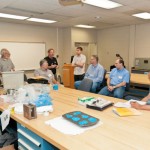 Jay Waddell, a partner in Plastics Concepts & Innovations, LLC (in black shirt), and Kathleen Boivin, materials engineer for CMT Materials Inc. (blue shirt at left), demonstrate construction of a Computer Numerical Control fixture in the Materials Testing Lab. Jay Waddell, a partner in Plastics Concepts & Innovations, LLC (in black shirt), and Kathleen Boivin, materials engineer for CMT Materials Inc. (blue shirt at left), demonstrate construction of a Computer Numerical Control fixture in the Materials Testing Lab.