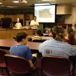 Fred Becker, dean of hospitality, talks with Camp ESCAPE youngsters. Fred Becker, dean of hospitality, talks with Camp ESCAPE youngsters.