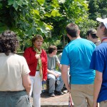 Guided by Carol A. Lugg, coordinator of matriculation and retention for the School of Natural Resources Management, campers find leafy shade in the "Idea Garden" on their way to a sawmill tour. Guided by Carol A. Lugg, coordinator of matriculation and retention for the School of Natural Resources Management, campers find leafy shade in the "Idea Garden" on their way to a sawmill tour.