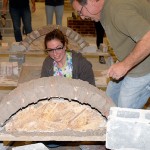 Knocking free the supporting form, instructor Glenn Luse shares a student's excitement when her arch holds firm. Knocking free the supporting form, instructor Glenn Luse shares a student's excitement when her arch holds firm.
