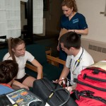 Paramedic and nursing students interview a patient actor outside the Keystone Dining Room.
