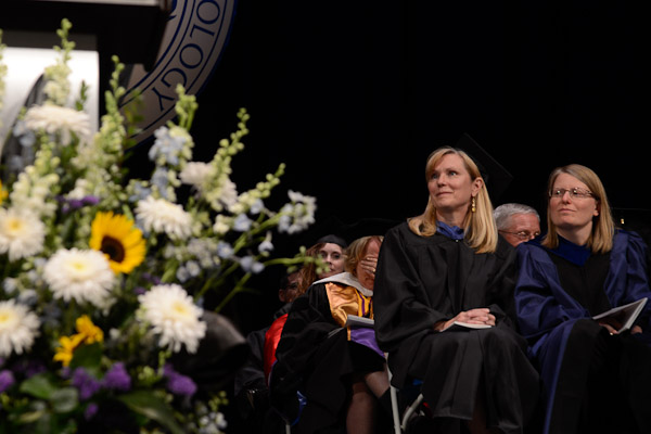 Gerri F. Luke, face buried at center, registers the shock of recognition as President Davie Jane Gilmour reveals her selection as Master Teacher.