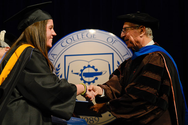 Board of Directors Chairman Robert A. Secor offers his encouragement to a new graduate.