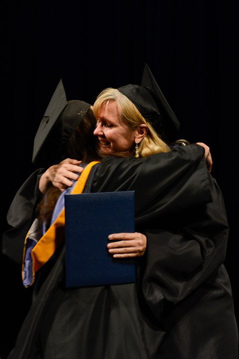 Anita R. Girton, assistant professor of computer information technology (right), congratulates daughter Anna Maree Manciet as she receives a bachelor's degree in web and interactive media.