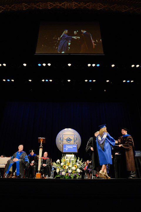 With a video screen projecting the activity below, a student accepts her diploma on the spacious CAC stage.
