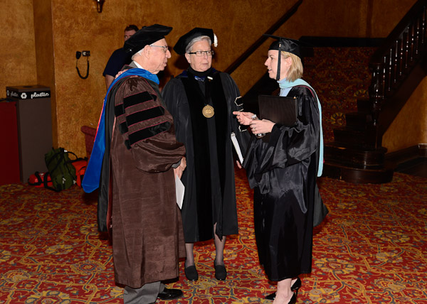 While waiting to enter the auditorium, President Gilmour (center) talks with Chairman Secor and Carolyn R. Strickland, assistant vice president for academic services.