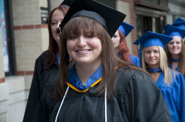 Ashley M. Stuck, an applied human services major, registers her graduation gladness .
