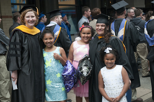 Board of Directors Award-winner Judy L. McMullen, an applied human services graduate, has her photo taken with her faculty adviser, Susan Slamka, and her proud children.