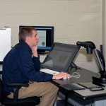 With organization treasurer John M. Confer on hand for moral support, Andrew R. Homsher, of Williamsport, walks his audience through his work on behalf of the Newberry Lions Club ...