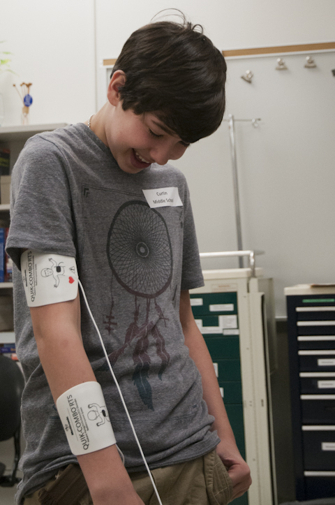 A Curtin Middle School student laughs as electrical impulses – used typically to pace a heartbeat – make his arm jump.