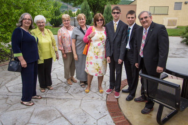 The family of the late Michael S. Fischer visits a commemorative brick on campus prior to Saturday morning's ceremony.