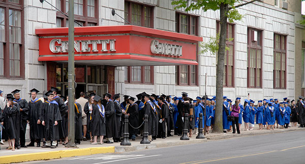 Near the corner of West Fourth and William streets – the crossroads between college life and the world beyond – students eagerly await graduation.