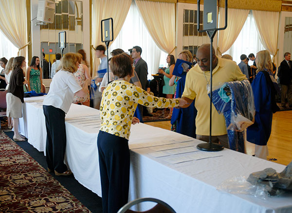 The Registrar's Office assists the steady flow of students checking in for commencement.