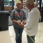 Forestry professor Dennis F. Ringling shows how to measure woodland acreage.