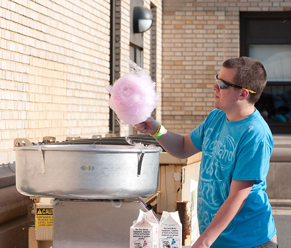 Fluffy cotton candy sweetens the carnival atmosphere.