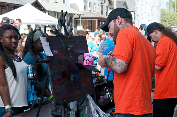 Artists at work, creating some of the novelty giveaways to Penn College students.