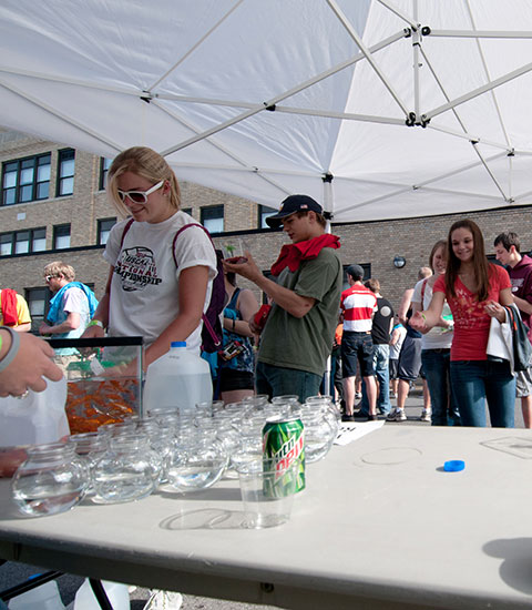 Hoping to take home a goldfish, a student sends her hopes (and pingpong ball) aloft.