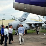 Bookended by two aircraft from the college's instructional fleet – a Grumman A-6 Intruder and a Boeing 727 – aviation instructor Michael R. Robison (back to camera) conducts a tour.