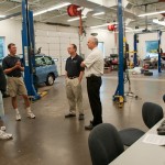 Talking with Christopher H. Van Stavoren, assistant professor, automotive (second from right), and John R. Cuprisin, associate professor, Ford ASSET (right)