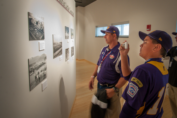 A member of the Aguadulce, Panama, team takes a photo of a photo in the Putsee Vannucci exhibit.