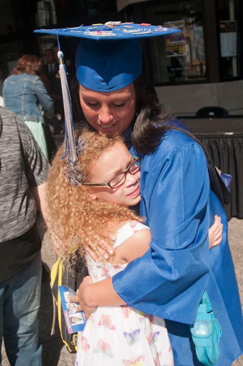 ... who sneaks a pre-commencement hug from a young well-wisher.