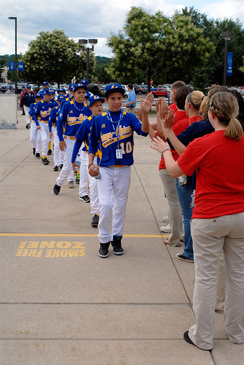 A row of high-fiving Penn College students greets the Europe/Africa team from the Czech Republic.
