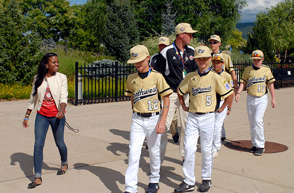 Yazmin E. Strauss, a student in business administration: marketing concentration, escorts her assigned team – the Northwest Region entry from Sammamish, Wash. – from the library to the cookout near the Bush Campus Center.