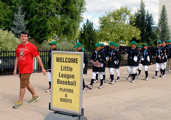 Student volunteer Ryan M. Enders, a technology management major, leads the Asia-Pacific team (from Chinese Taipei) past a