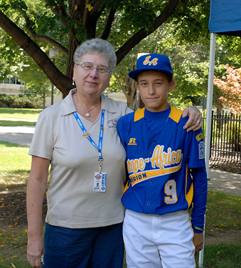 Little League host Carol Weinhoffer joins the only girl in this year's Series: the Czech Republic's Eliska Stejskalova.