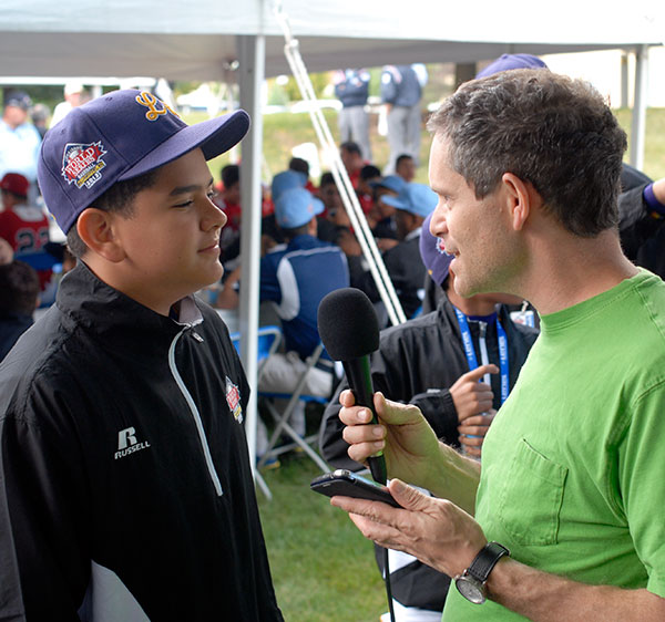 Physics instructor Joseph E. LeBlanc, who is fluent in Spanish and Japanese, interviews a Latin American player for Williamsport Independent Media.