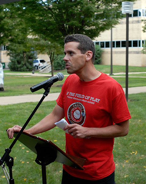 College Information and Community Relations' Tom Speicher, a longtime member of the Series broadcast team, helps keep the program on schedule.