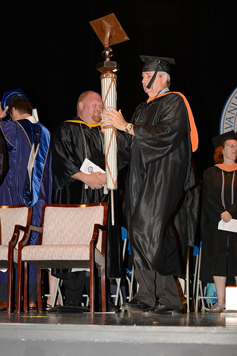 Penn College Education Association President Kenneth C. Kuhns, assistant professor of electrical technology/occupations, carries the college mace.
