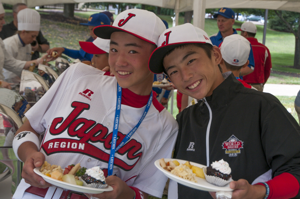 Members of the Japan team pause for a photo while filling their plates.