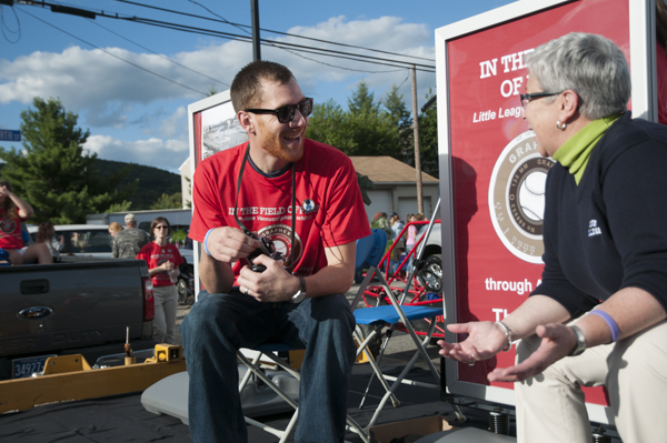 Surgical technology student Bryan L. Coffey swaps stories with college President Davie Jane Gilmour while waiting for the parade to begin.