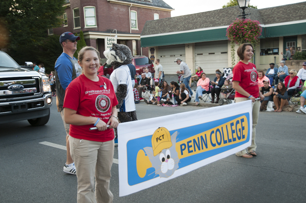Surgical technology student Heather R. Krepps and baking and pastry arts major Samantha-Jo Bradley lead the Penn College parade entry.