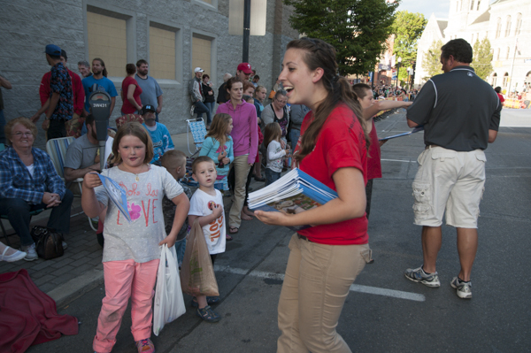 Technology management student Whitnie-Rae Mays hands out coloring books with a smile.