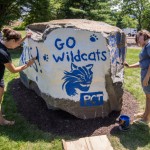 Student leaders Whitnie-Rae Mays (left) and April M. Tucker blend artistic ability and school spirit in adorning a new campus landmark Monday.