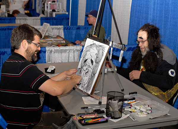 Caricaturist John Sprague draws a member of the USS Susquehannock Starfleet Chapter in a popular Artist Alley attraction.