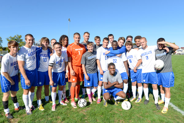 The men's soccer team pauses for an impromptu team photo prior to midafternoon play.