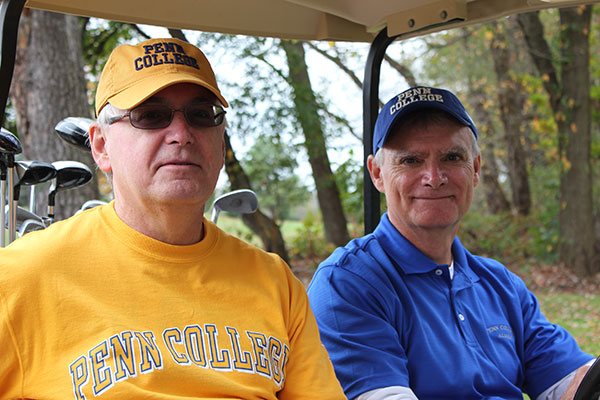 Brothers Mike (left) and Jim Cunningham show their Penn College allegiance.