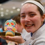 Samantha-Jo M. Bradley is all smiles with her completed sugar skull. The baking and pastry arts sophomore was among students of Chef Charles R. Niedermyer II who assisted their instructor with the sweet details.