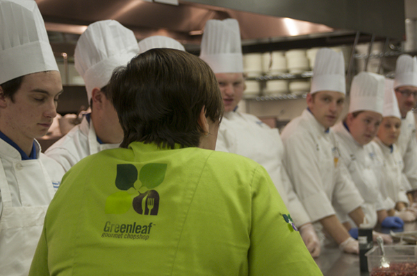 Students listen closely to the chef’s instructions.