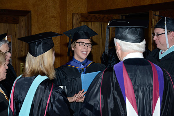 A crowd forms around Eric J. Palanko, who, in addition to representing his class, received the President's Award for leadership to the college.