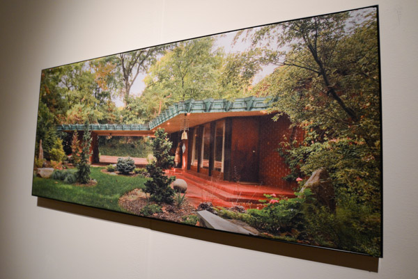 A beautiful exterior photograph of Samara is displayed on a gallery wall.