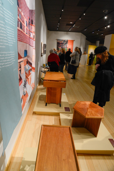 Gallery guests inspect end tables.