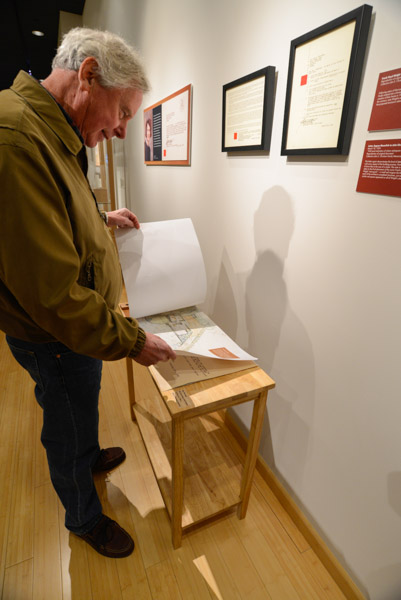 Roger Shipley, whose work is displayed in Penn College's Art on Campus initiative, pores over architectural drawings.