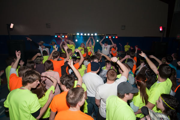 Brightly clad students form a festive sea.