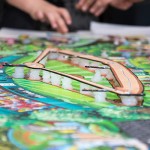 Base paths float above the colorful playing surface on blobs of near-invisible support.